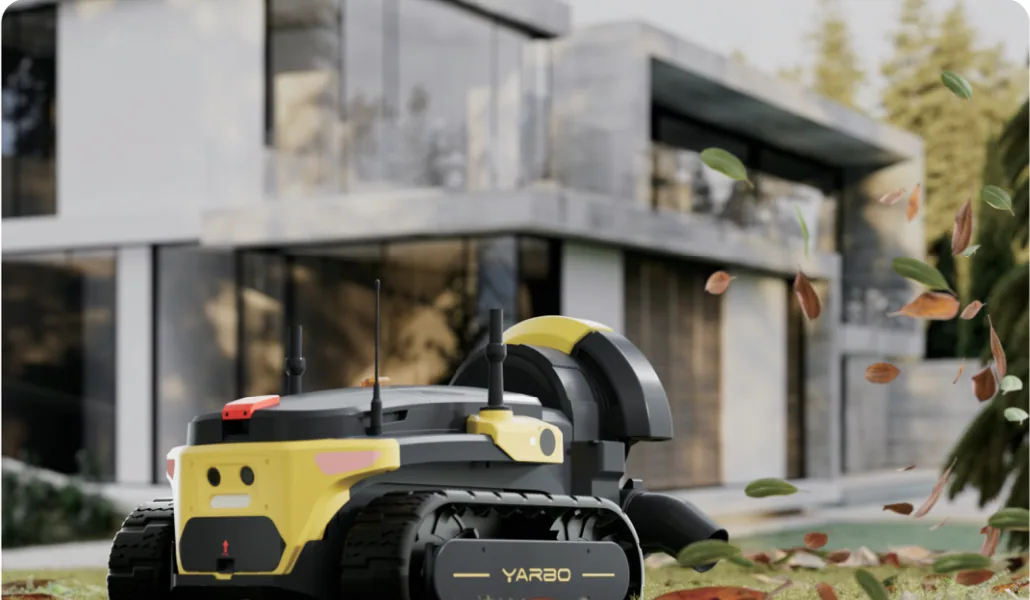 Yarbo Blower Module clearing leaves near a home.