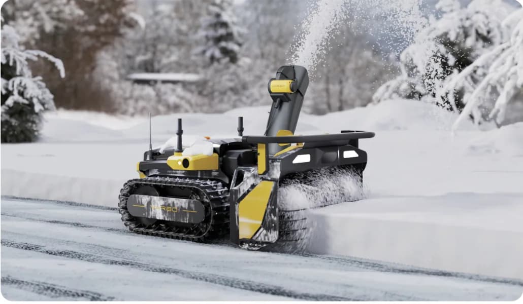 Yarbo Snow Blower Module clearing snow on a driveway.